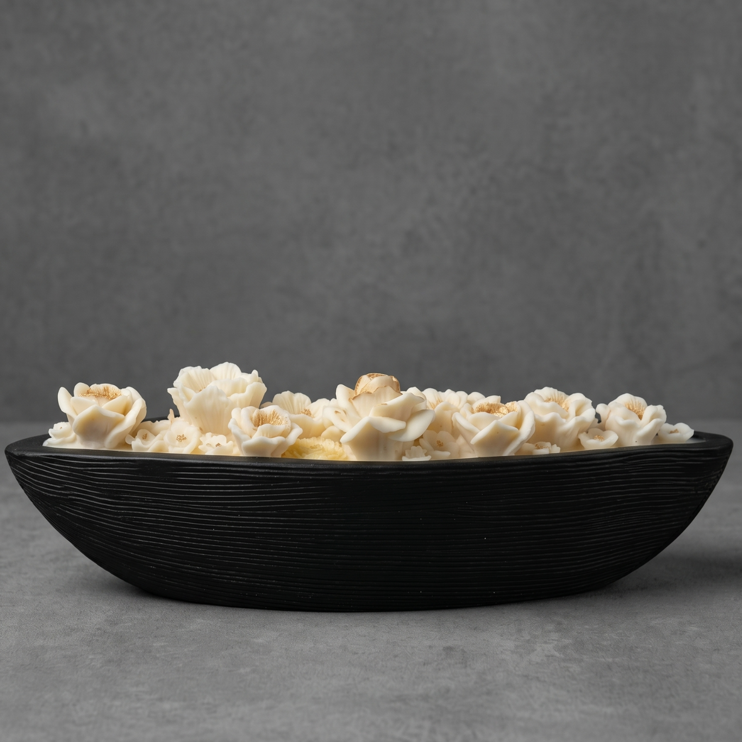Black bowl filled with popcorn on a gray background