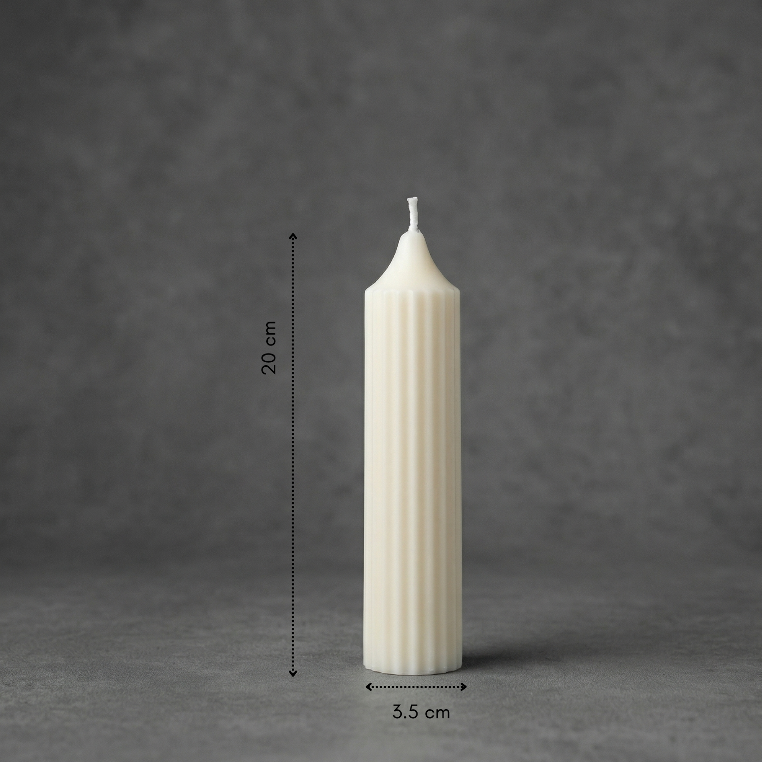 White candle with dimensions on a gray background