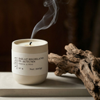 Candle labeled 'Dalat Highland in Autumn' with smoke rising, placed on a surface with a dark background.