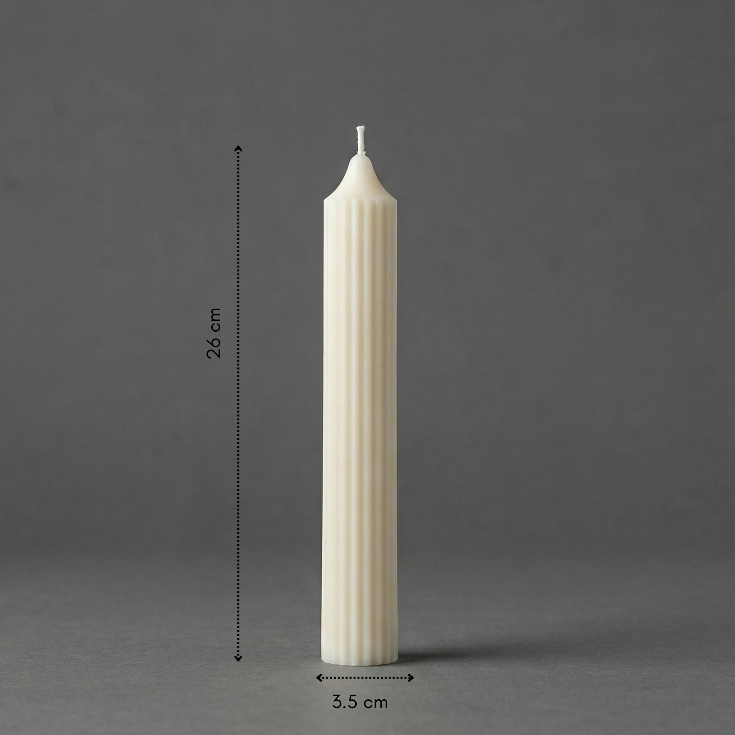 White candle with dimensions on a gray background