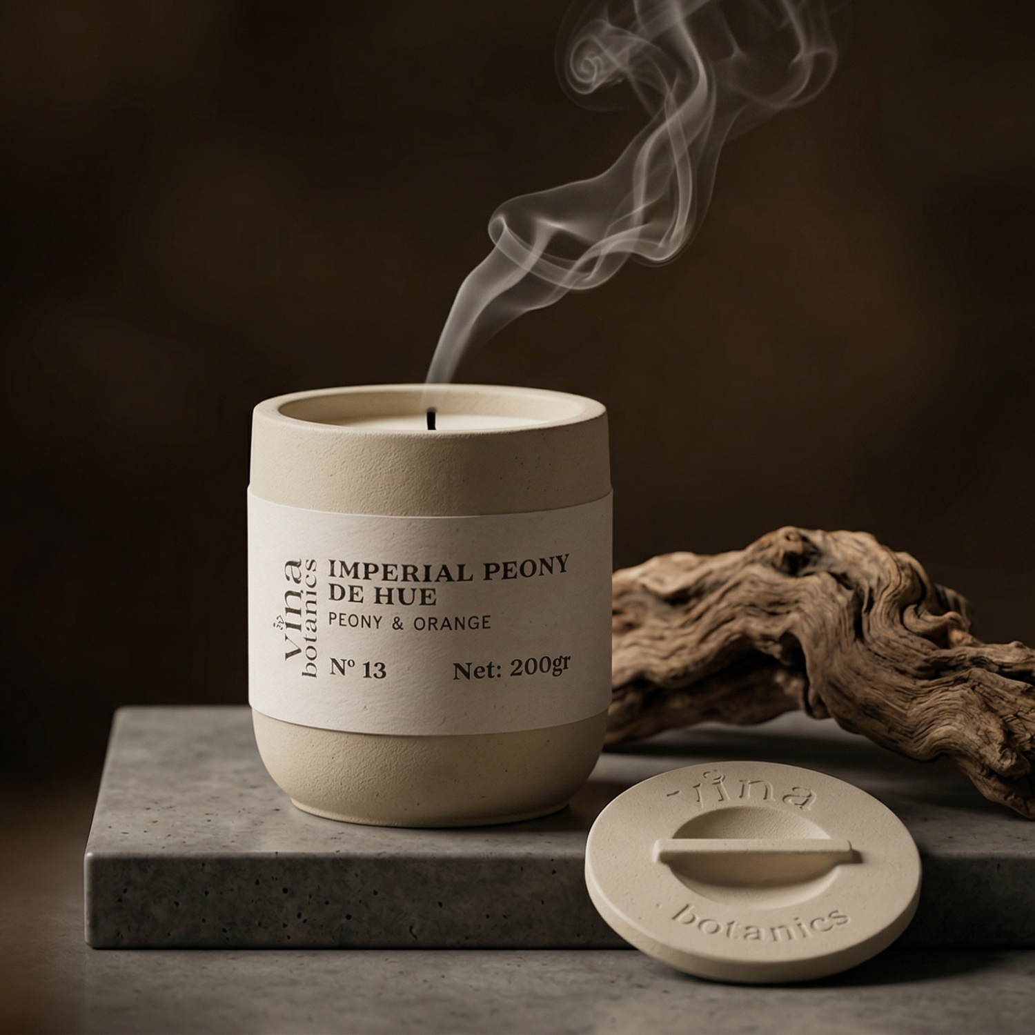 Ceramic candle with 'Imperial Peony de Hue' label on a dark background