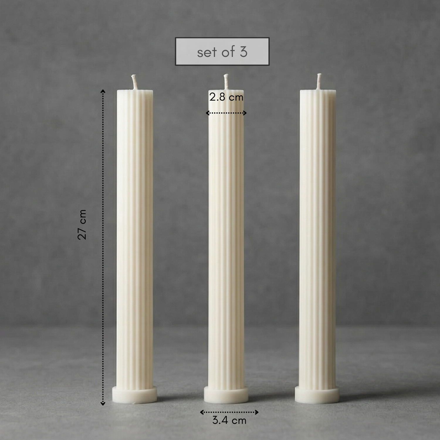 Three white candles of different heights on a gray background with measurements.