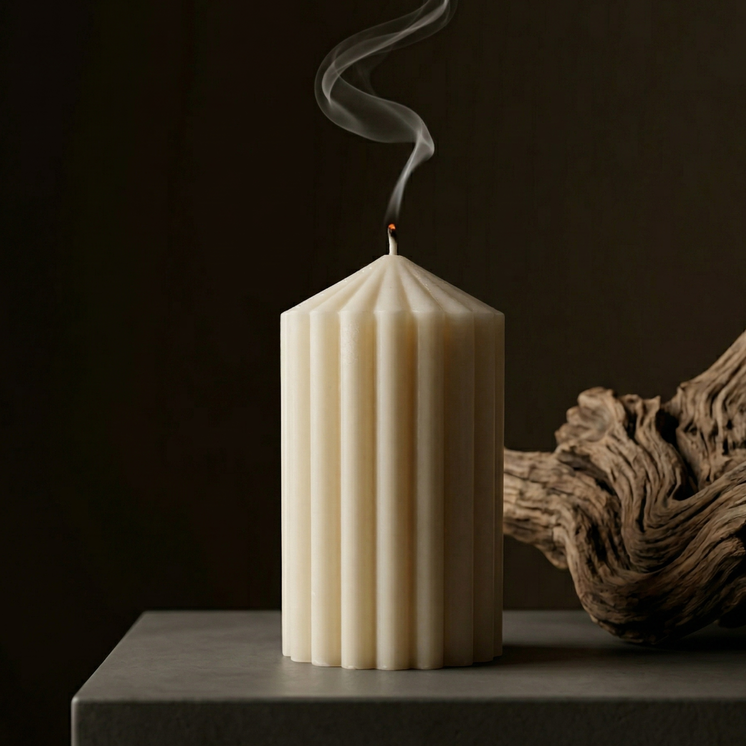 White textured candle with a wick on a dark background