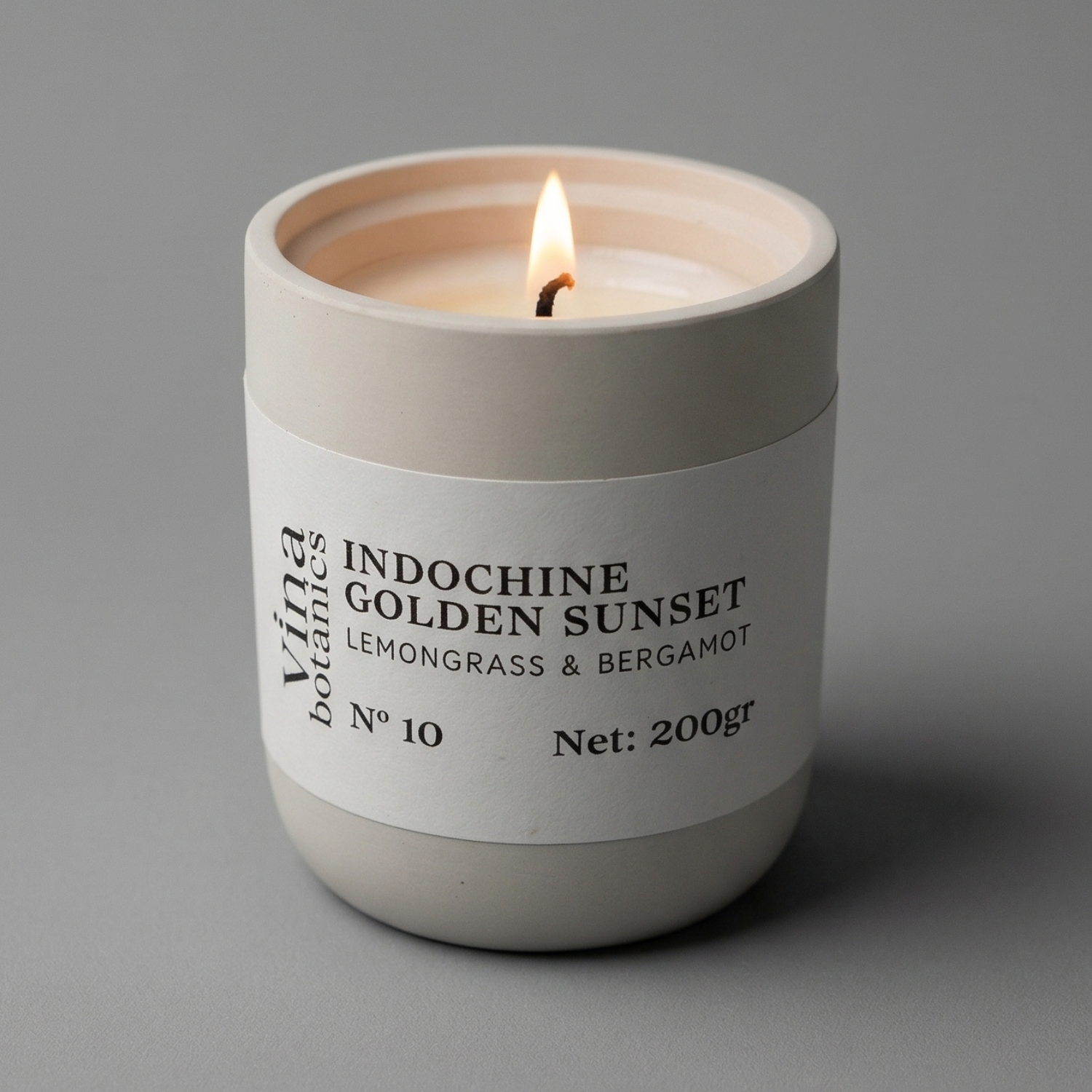 Candle in a white container with a label on a gray background