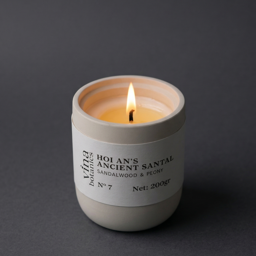 Candle in a white container with a label on a dark background