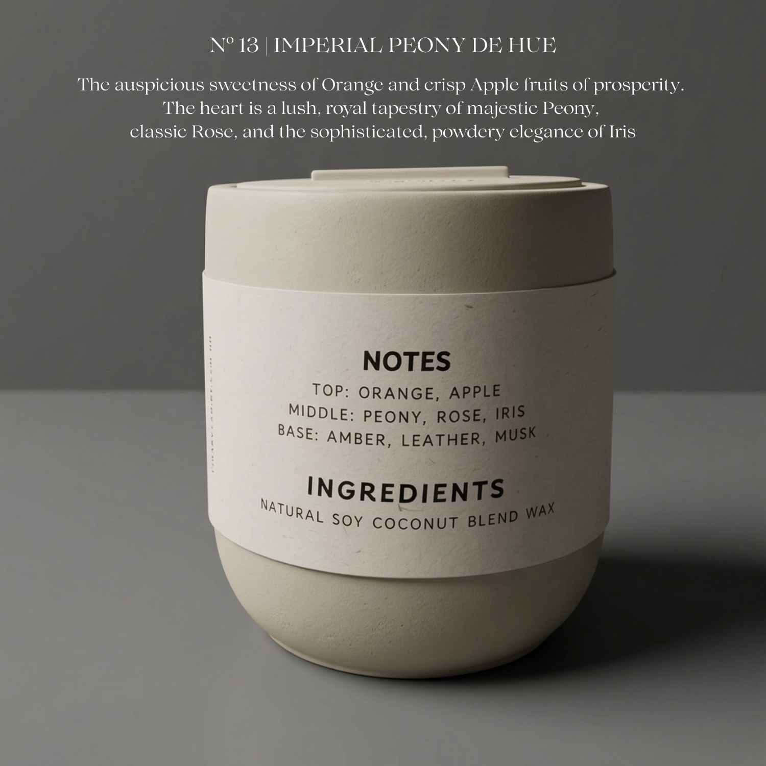 Candle with label detailing notes, ingredients, and description on a gray background