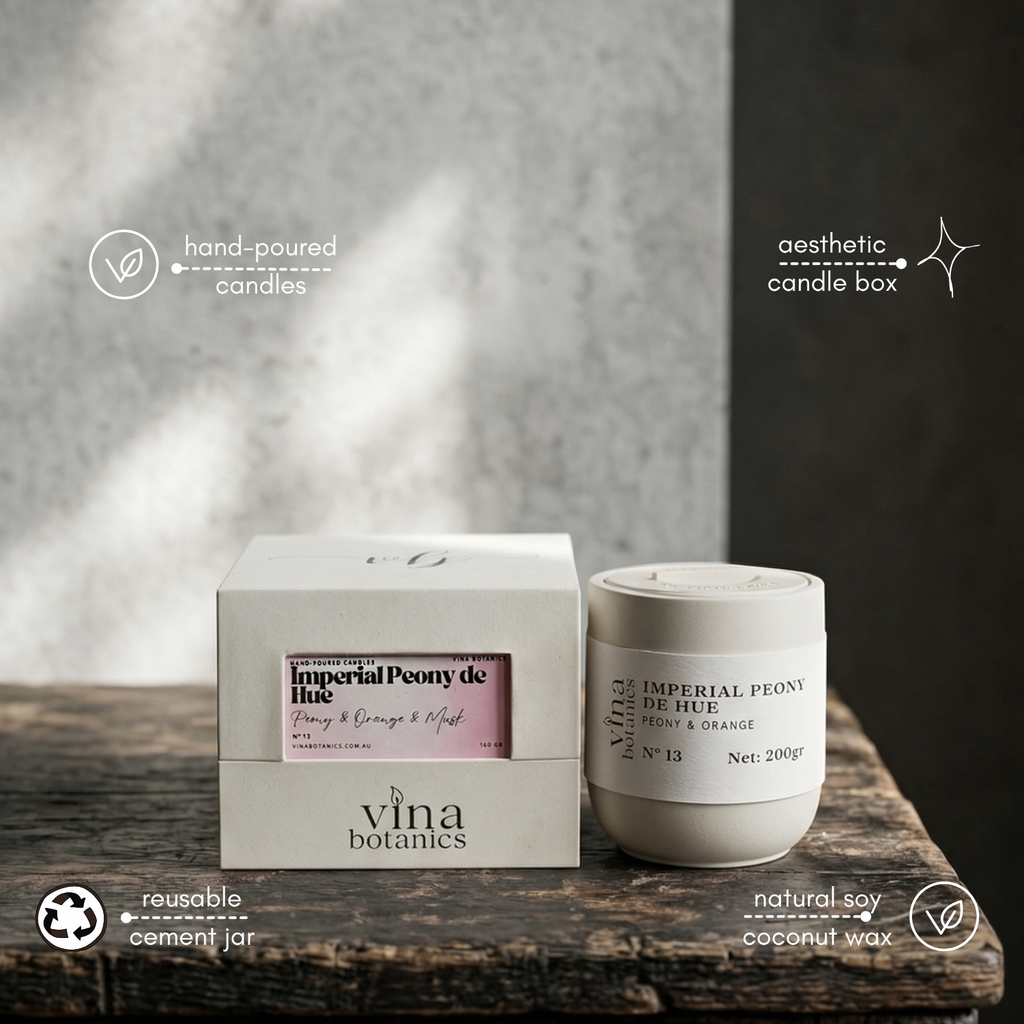 Vina Botanics candle and packaging on a wooden surface with a blurred background