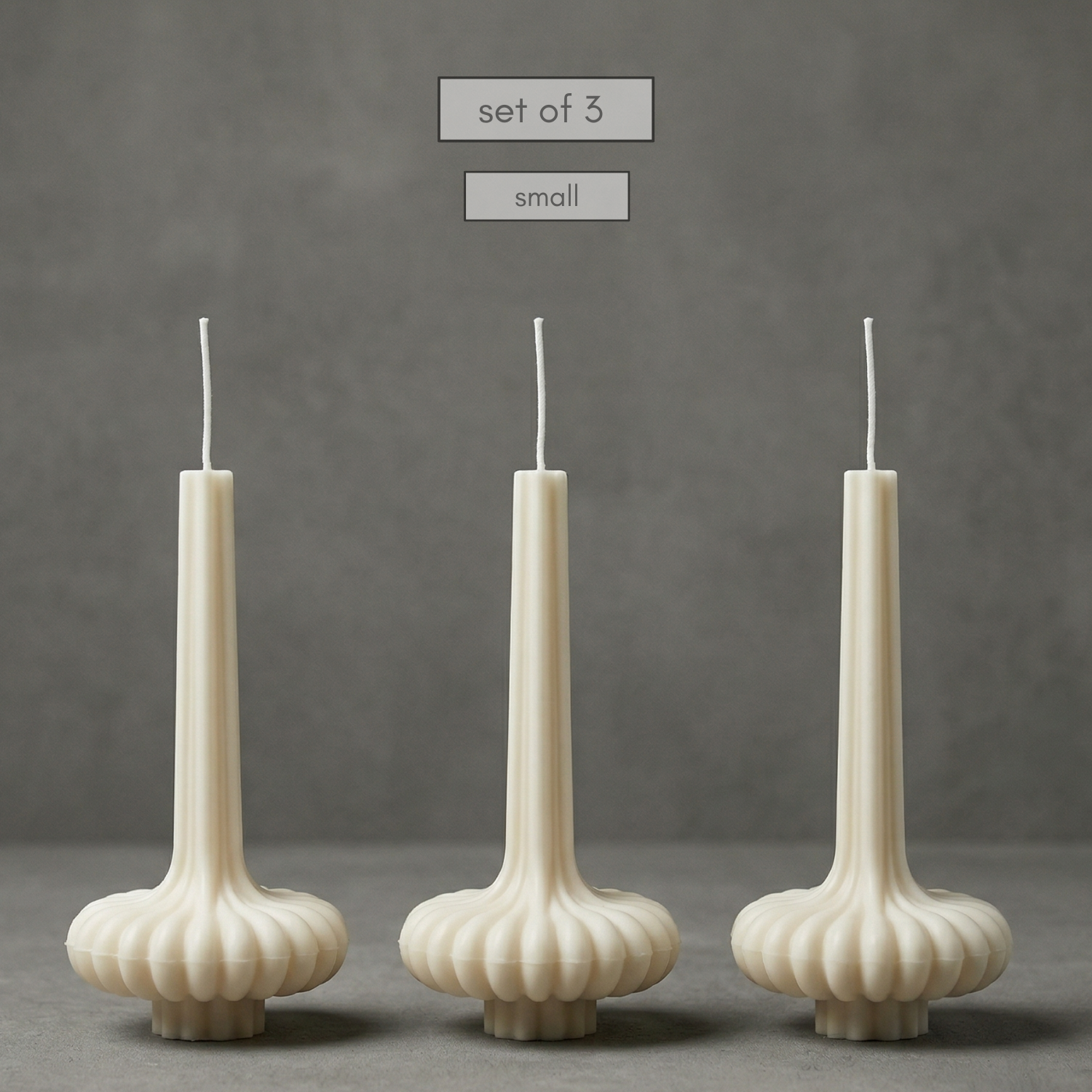 Three small ribbed candles on a gray background with text 'set of 3' and 'small'.