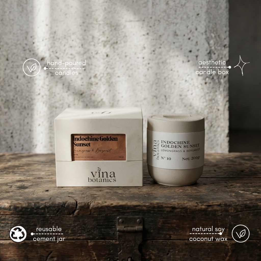 Vina Botanics candle and packaging on a wooden surface with a concrete wall background