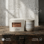 Vina Botanics candle and packaging on a wooden surface with a concrete wall background