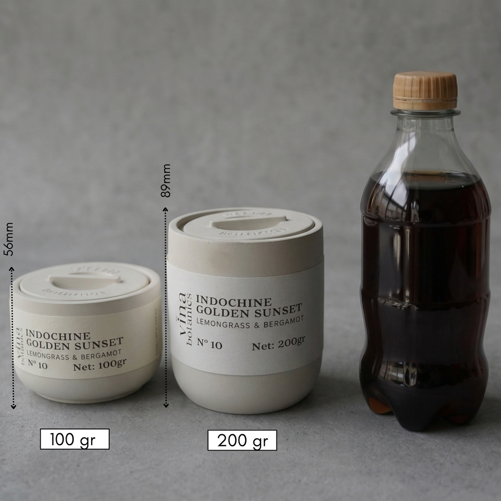 Two containers labeled 'Indochine Golden Sunset' with measurements and a bottle of dark liquid on a gray background.